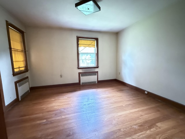 909 Randolph Rd, Middletown, CT 06457 - unfurnished room with radiator, wood finished floors, and baseboards