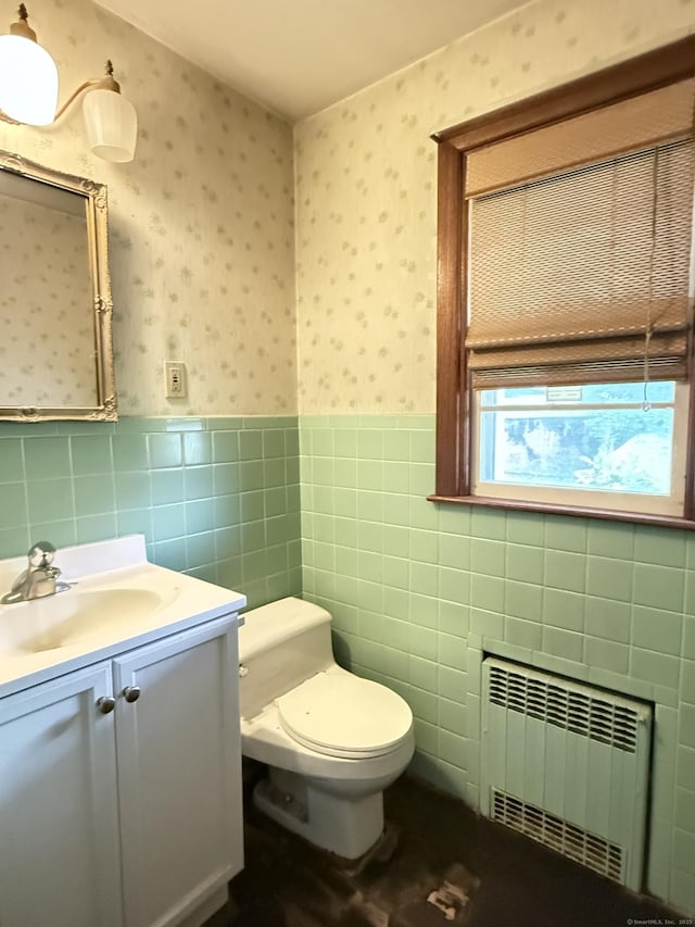 909 Randolph Rd, Middletown, CT 06457 - half bath with radiator heating unit, wallpapered walls, toilet, wainscoting, and vanity