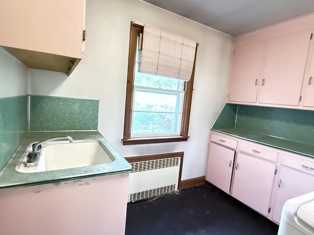 909 Randolph Rd, Middletown, CT 06457 - washroom with radiator heating unit, cabinet space, and baseboards