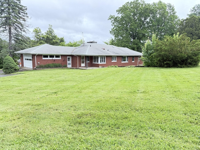 909 Randolph Rd, Middletown, CT 06457 - rear view of house with a garage, brick siding, and a yard