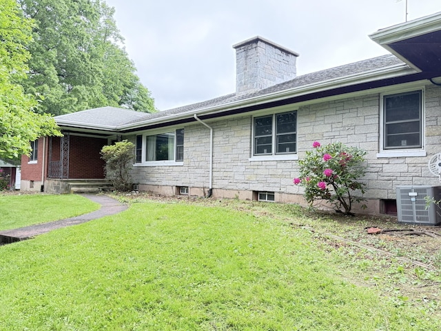 909 Randolph Rd, Middletown, CT 06457 - view of property exterior featuring central AC, a lawn, a chimney, a shingled roof, and stone siding