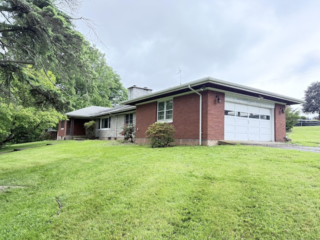 909 Randolph Rd, Middletown, CT 06457 - view of property exterior with a garage, a chimney, asphalt driveway, brick siding, and a yard