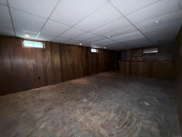 909 Randolph Rd, Middletown, CT 06457 - basement featuring a paneled ceiling and wooden walls