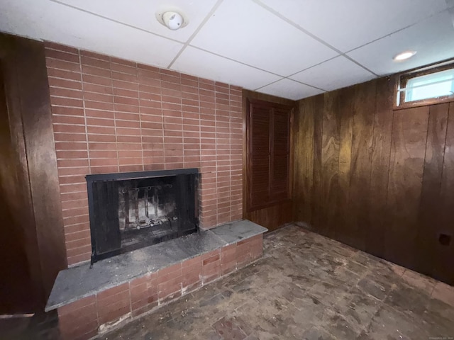 909 Randolph Rd, Middletown, CT 06457 - detailed view of a fireplace, wood walls, a smoke detector, and a paneled ceiling