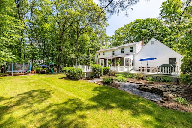 825 Copper Hill Rd, Suffield, CT 06093 - view of green lawn with a trampoline, a playground, a sunroom, and a wooden deck