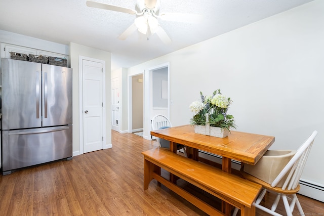 825 Copper Hill Rd, Suffield, CT 06093 - dining room featuring light wood-type flooring, ceiling fan, and a baseboard radiator