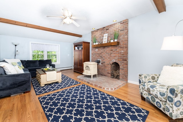 825 Copper Hill Rd, Suffield, CT 06093 - living room with baseboard heating, a ceiling fan, wood finished floors, and a wood stove