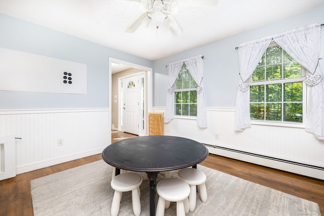 825 Copper Hill Rd, Suffield, CT 06093 - dining room featuring wainscoting, wood finished floors, a baseboard radiator, and ceiling fan