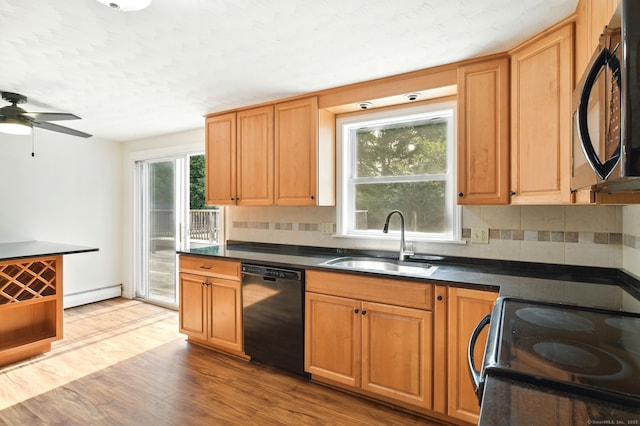 3 Birchwood Ter, Enfield, CT 06082 - kitchen featuring black appliances, a sink, baseboard heating, dark countertops, and decorative backsplash