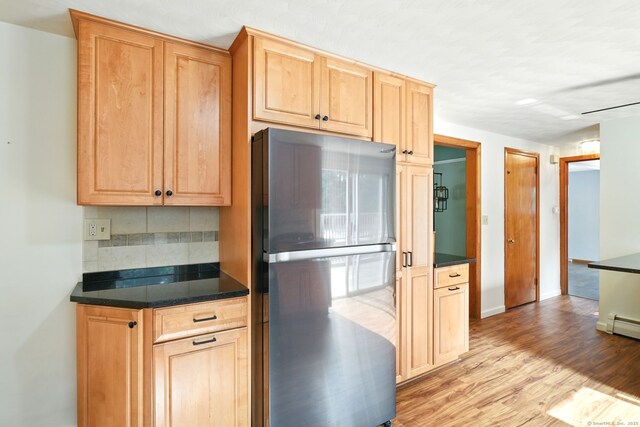 3 Birchwood Ter, Enfield, CT 06082 - kitchen featuring freestanding refrigerator, tasteful backsplash, light wood-type flooring, dark countertops, and light brown cabinets