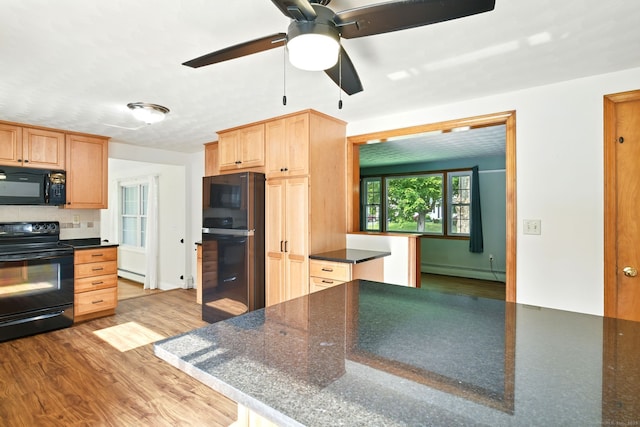 3 Birchwood Ter, Enfield, CT 06082 - kitchen featuring black appliances, baseboard heating, dark countertops, a baseboard heating unit, and wood finished floors