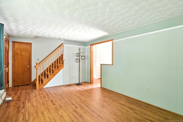 3 Birchwood Ter, Enfield, CT 06082 - unfurnished room with wood finished floors, stairs, and a textured ceiling