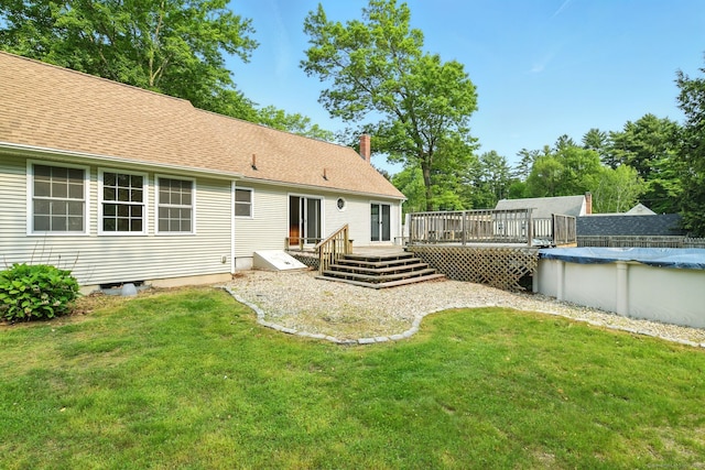 3 Birchwood Ter, Enfield, CT 06082 - rear view of property featuring a deck, a covered pool, a yard, and a chimney