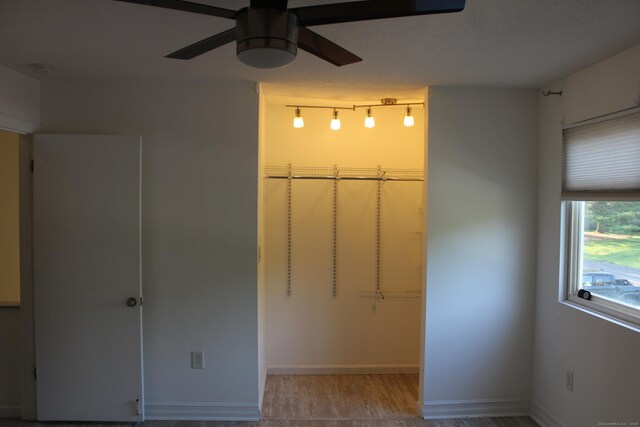 9 Watch Hill Cir Unit 9, Cromwell, CT 06416 - unfurnished bedroom with baseboards, wood finished floors, a closet, and a walk in closet