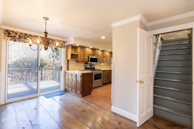 884 Black Rock Tpke, Easton, CT 06612 - kitchen with appliances with stainless steel finishes, a chandelier, ornamental molding, light countertops, and light wood finished floors