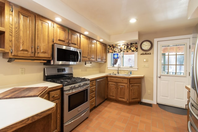 884 Black Rock Tpke, Easton, CT 06612 - kitchen with appliances with stainless steel finishes, a sink, brown cabinetry, light countertops, and recessed lighting