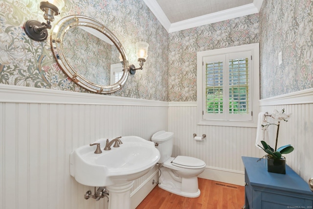 19 Father Peters Ln, New Canaan, CT 06840 - bathroom with wallpapered walls, a wainscoted wall, wood finished floors, and crown molding