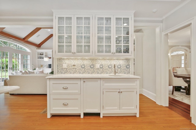 19 Father Peters Ln, New Canaan, CT 06840 - kitchen with glass insert cabinets, light wood-type flooring, white cabinets, ornamental molding, and light countertops