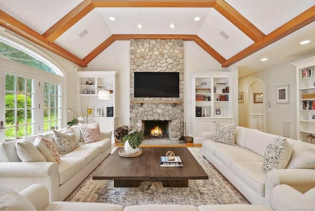 19 Father Peters Ln, New Canaan, CT 06840 - living area with vaulted ceiling, built in features, a stone fireplace, wood finished floors, and recessed lighting