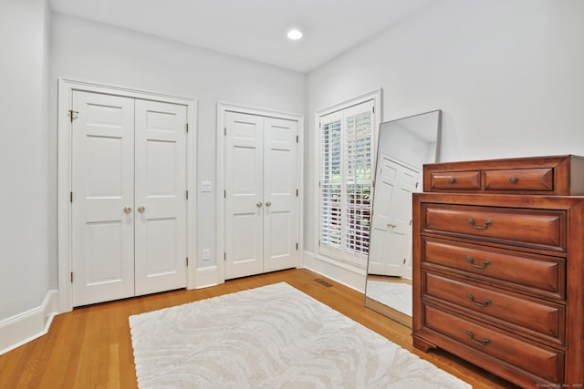 19 Father Peters Ln, New Canaan, CT 06840 - bedroom featuring multiple closets, light wood-type flooring, and recessed lighting