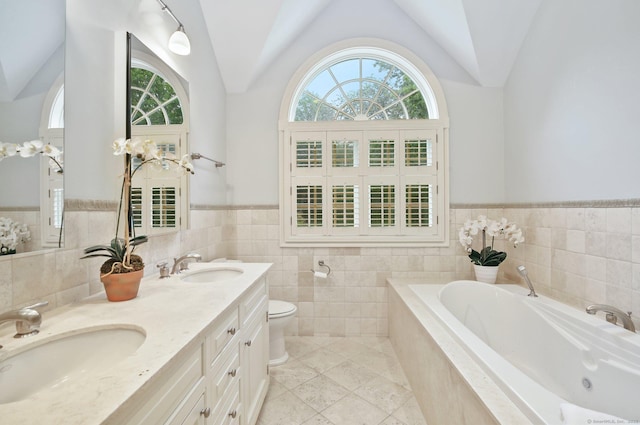 19 Father Peters Ln, New Canaan, CT 06840 - bathroom with lofted ceiling, a garden tub, tile walls, double vanity, and tile patterned floors