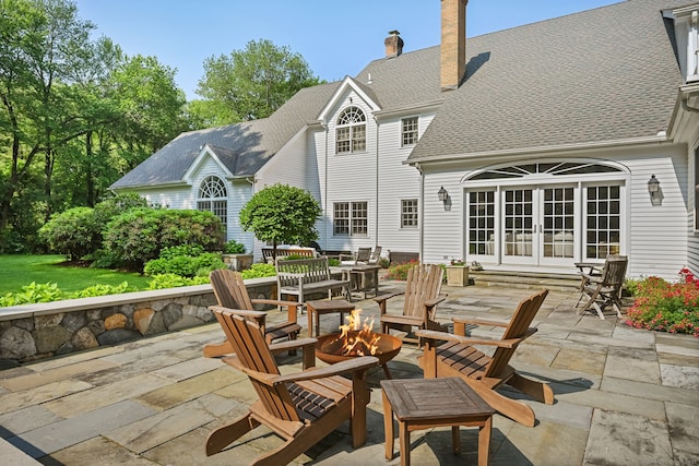 19 Father Peters Ln, New Canaan, CT 06840 - view of patio / terrace with french doors and a fire pit