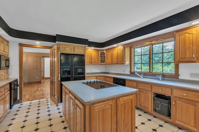 192 Palmer Rd, Chaplin, CT 06235 - kitchen with light floors, black appliances, glass insert cabinets, and a center island