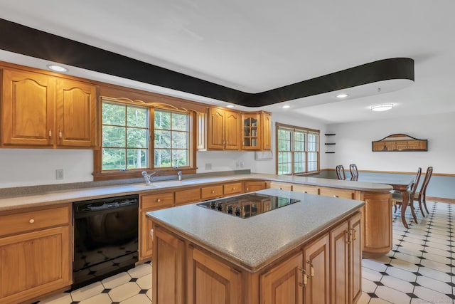 192 Palmer Rd, Chaplin, CT 06235 - kitchen with black appliances, a peninsula, a kitchen island, brown cabinetry, and recessed lighting