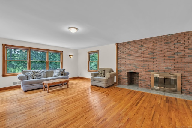 192 Palmer Rd, Chaplin, CT 06235 - living room with wood finished floors and a brick fireplace