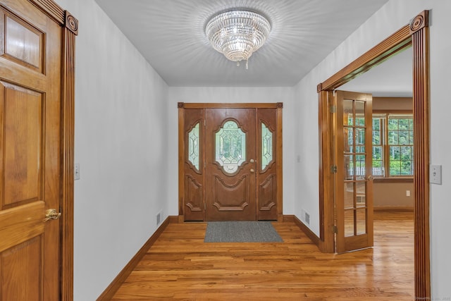 192 Palmer Rd, Chaplin, CT 06235 - entrance foyer with light wood-style flooring and a chandelier