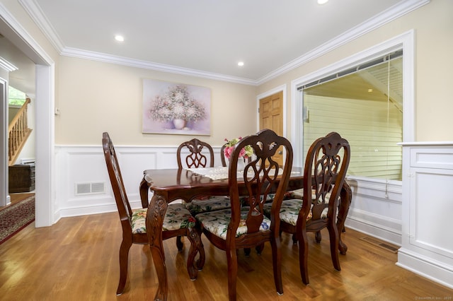 10 Dry Hill Ct, Norwalk, CT 06851 - dining space featuring light wood finished floors, ornamental molding, a decorative wall, wainscoting, and recessed lighting