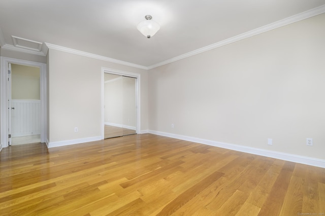 10 Dry Hill Ct, Norwalk, CT 06851 - unfurnished bedroom featuring a closet, light wood-style floors, ornamental molding, attic access, and baseboards