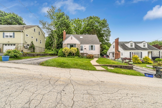 214 Thames St, New London, CT 06320 - view of front of home with driveway, a chimney, and a front yard