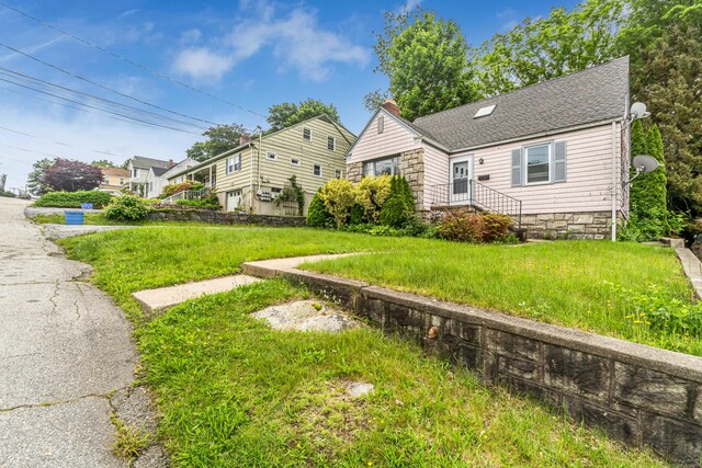 214 Thames St, New London, CT 06320 - view of front of home featuring a chimney, a front lawn, and roof with shingles