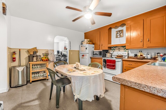 214 Thames St, New London, CT 06320 - kitchen featuring white appliances, ceiling fan, a sink, arched walkways, and light countertops
