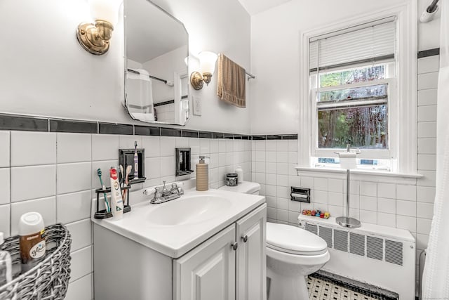 214 Thames St, New London, CT 06320 - full bath with radiator heating unit, tile walls, vanity, toilet, and wainscoting