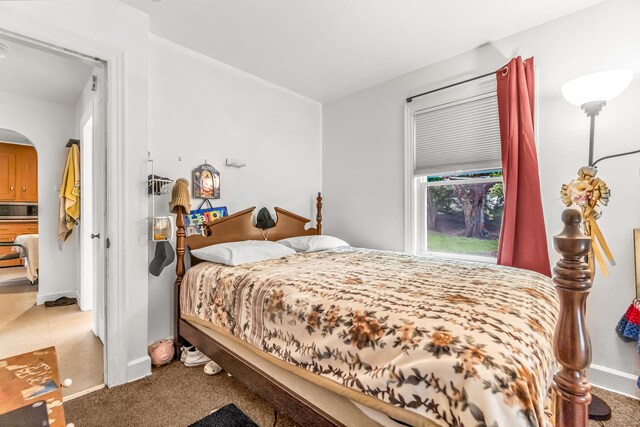 214 Thames St, New London, CT 06320 - bedroom with arched walkways, baseboards, and light carpet