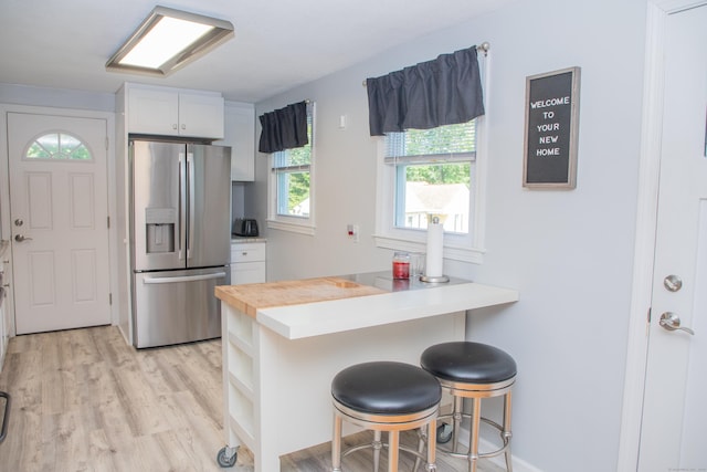 158 Jones Dr, New Britain, CT 06053 - kitchen with stainless steel fridge, a breakfast bar, plenty of natural light, and a peninsula