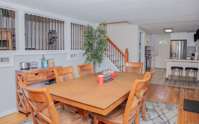 158 Jones Dr, New Britain, CT 06053 - dining room featuring stairway and light wood-style floors