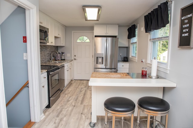 158 Jones Dr, New Britain, CT 06053 - kitchen featuring stainless steel appliances, a sink, healthy amount of natural light, and light wood-style floors