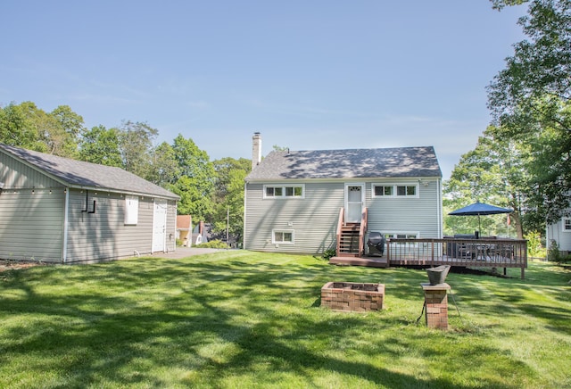 158 Jones Dr, New Britain, CT 06053 - back of house featuring a lawn, a wooden deck, a fire pit, and a chimney