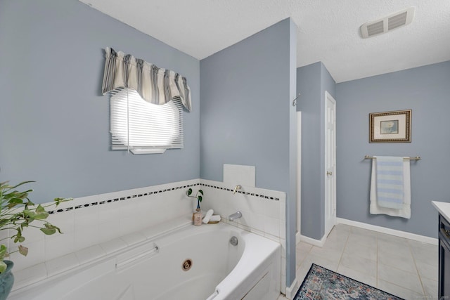 61 Pine Rd, Suffield, CT 06093 - full bath with vanity, a jetted tub, baseboards, tile patterned floors, and a textured ceiling