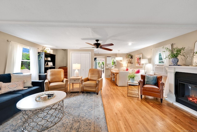 61 Pine Rd, Suffield, CT 06093 - living room with light wood-style flooring, a glass covered fireplace, and a ceiling fan