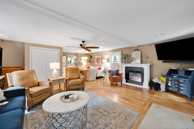 61 Pine Rd, Suffield, CT 06093 - living room featuring a glass covered fireplace, light wood-style floors, and ceiling fan