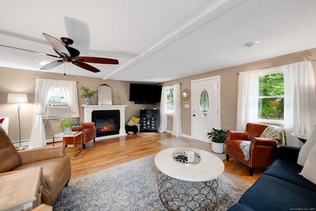 61 Pine Rd, Suffield, CT 06093 - living room featuring light wood finished floors, a glass covered fireplace, ceiling fan, cooling unit, and beam ceiling