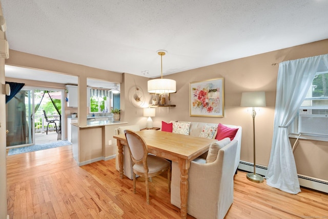 61 Pine Rd, Suffield, CT 06093 - dining area with light wood-style flooring, baseboards, baseboard heating, and cooling unit