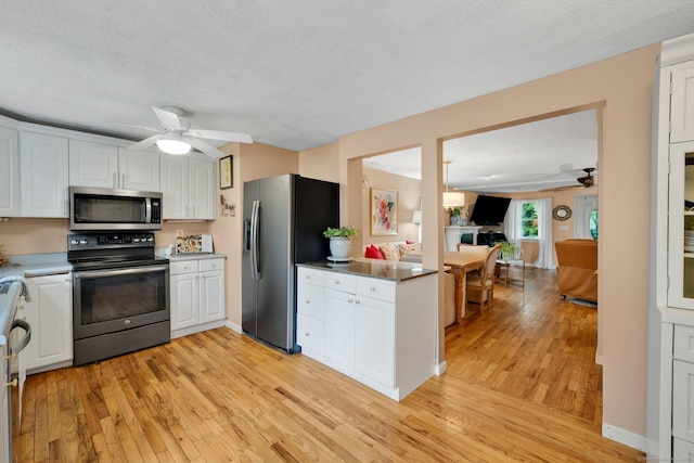 61 Pine Rd, Suffield, CT 06093 - kitchen featuring stainless steel appliances, a ceiling fan, light wood-style flooring, white cabinets, and a textured ceiling