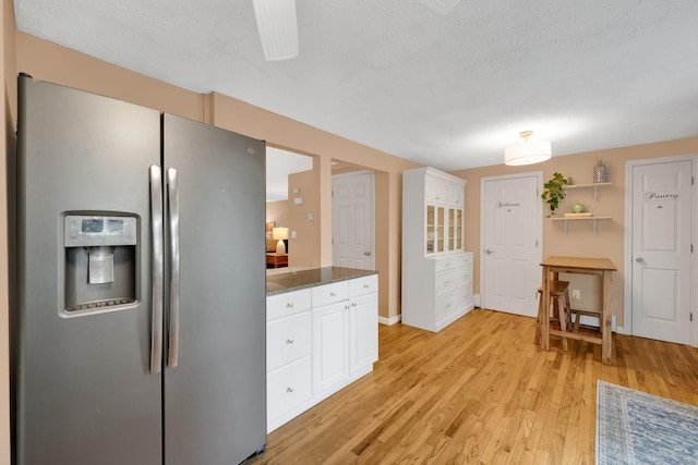 61 Pine Rd, Suffield, CT 06093 - kitchen with stainless steel fridge, white cabinets, light wood finished floors, a textured ceiling, and open shelves