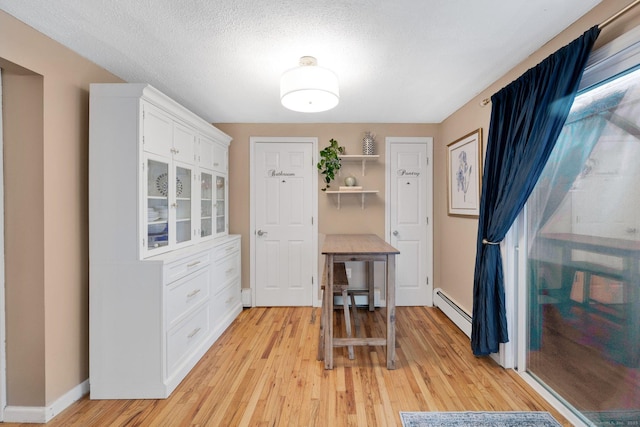 61 Pine Rd, Suffield, CT 06093 - dining area featuring light wood-style flooring, baseboard heating, baseboards, and a textured ceiling