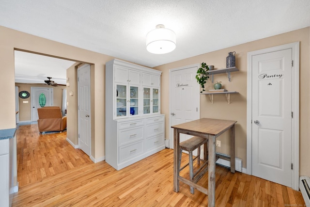 61 Pine Rd, Suffield, CT 06093 - kitchen featuring light wood-style flooring, white cabinets, ceiling fan, baseboard heating, and open shelves